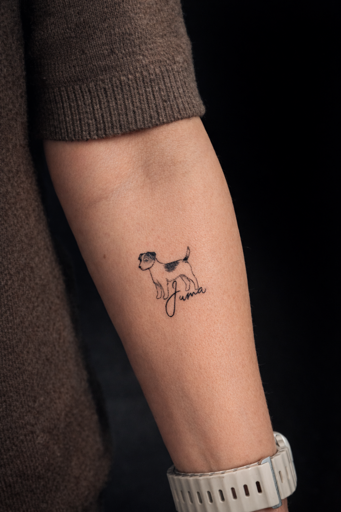 Fineline Hund Tattoo mit Schriftzug auf dem Unterarm gestochen im Tattoo Studio Ink Society in Rheda-Wiedenbrück