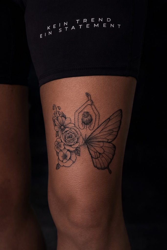 Schmetterling Tattoo mit Blumenmotiv im Fineline Stil auf dem Oberschenkel gestochen im Tattoo Studio Ink Society in Rheda-Wiedenbrück